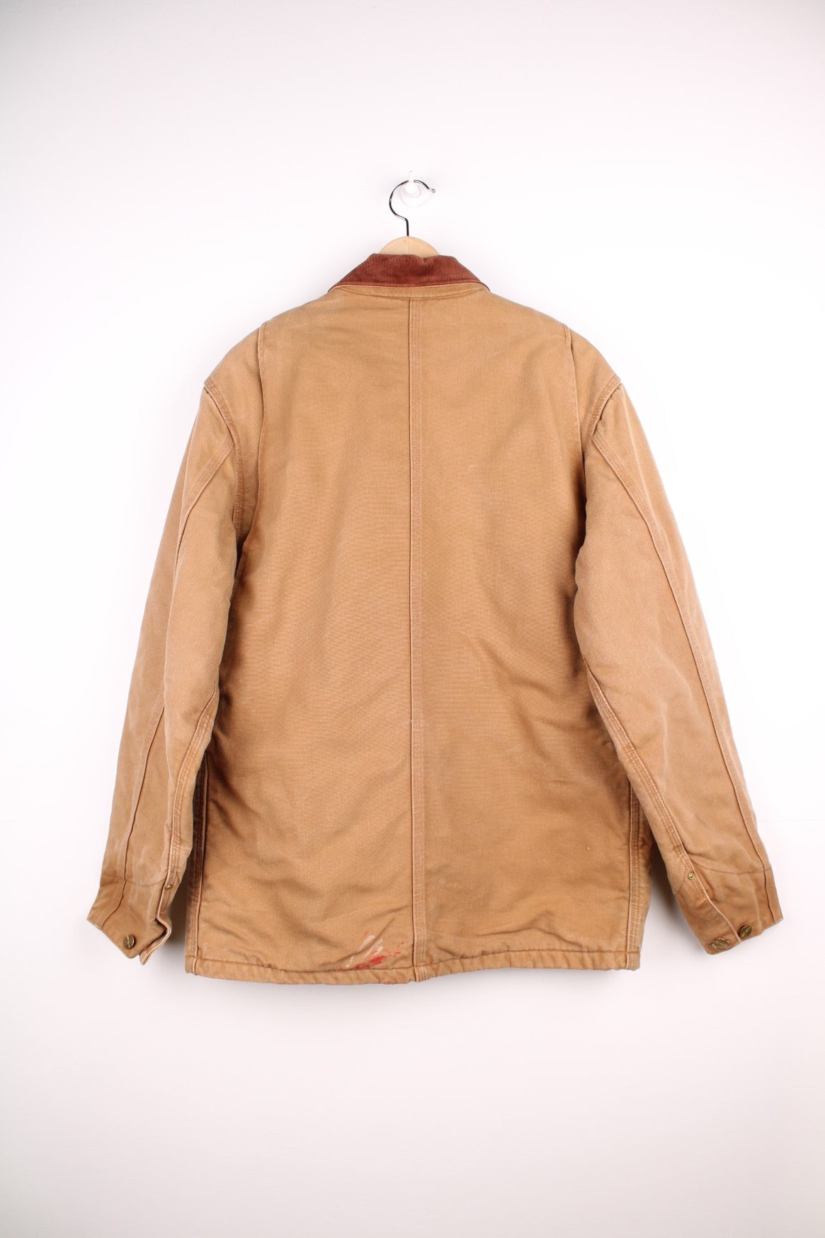 Carhartt Chore Jacket in a brown tanned colourway with a corduroy collar, buttons up and has multiple pockets, blanket lining, and the logo embroiderd on the front. 