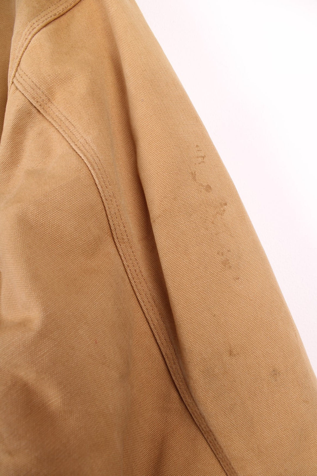 Carhartt Chore Jacket in a tanned colourway with a corduroy collar, buttons up and has multiple pockets, blanket lining, and the logo embroidered on the front. 