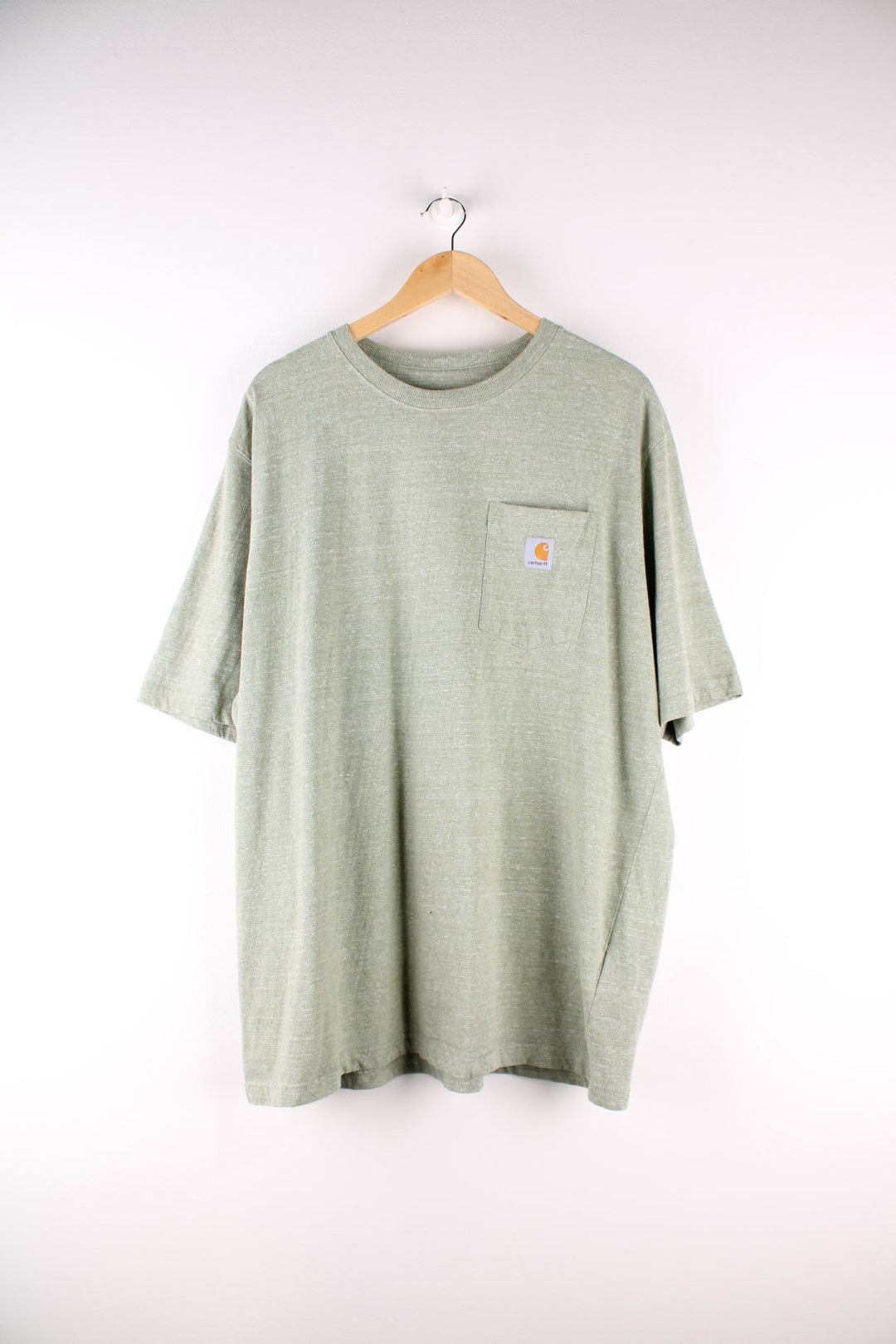 Carhartt T-Shirt in a light sage green colourway with a patch pocket and logo stitched onto the front.