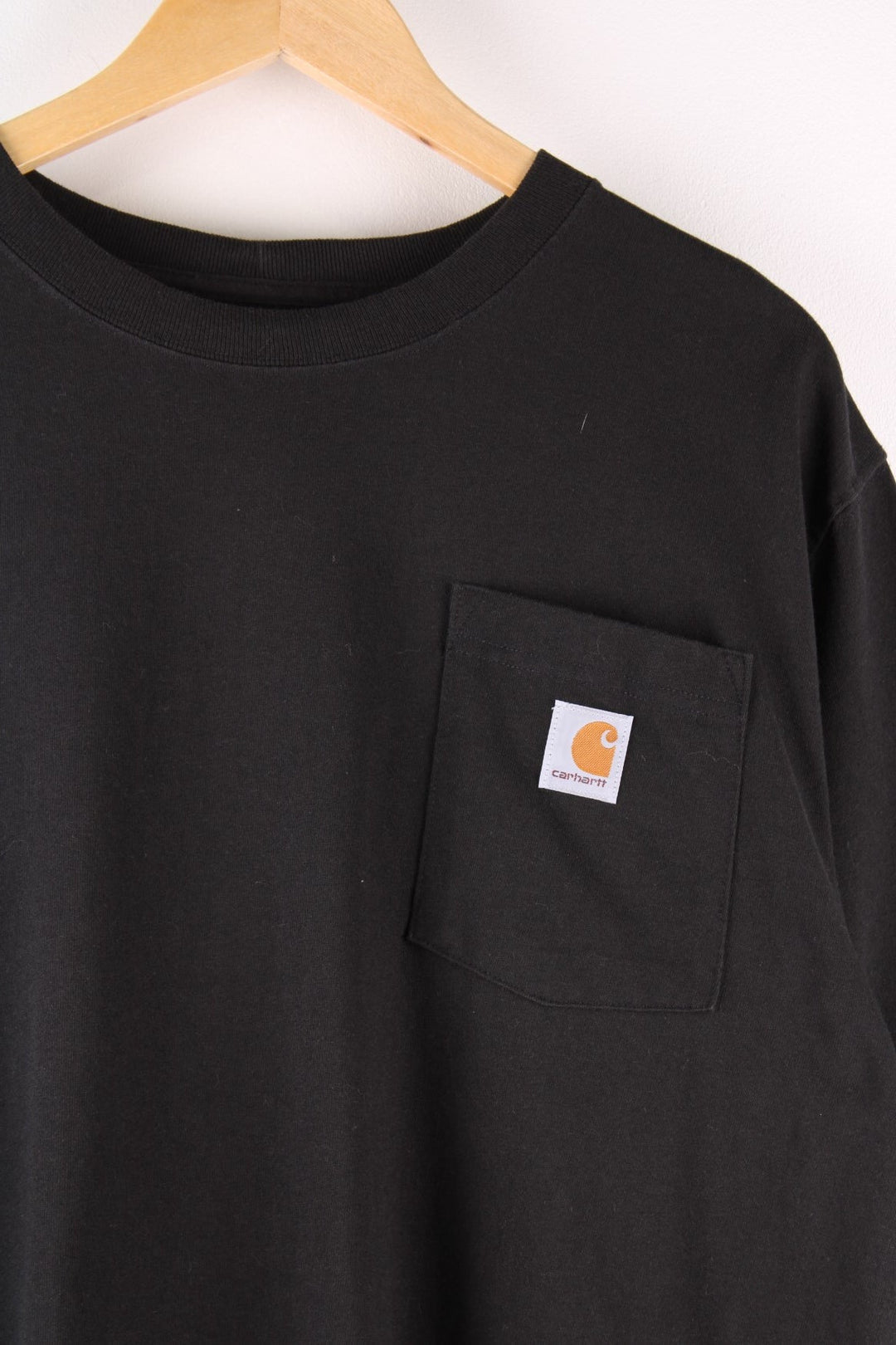 Carhartt T-Shirt in a black colourway with a patch pocket and logo stitched onto the front.