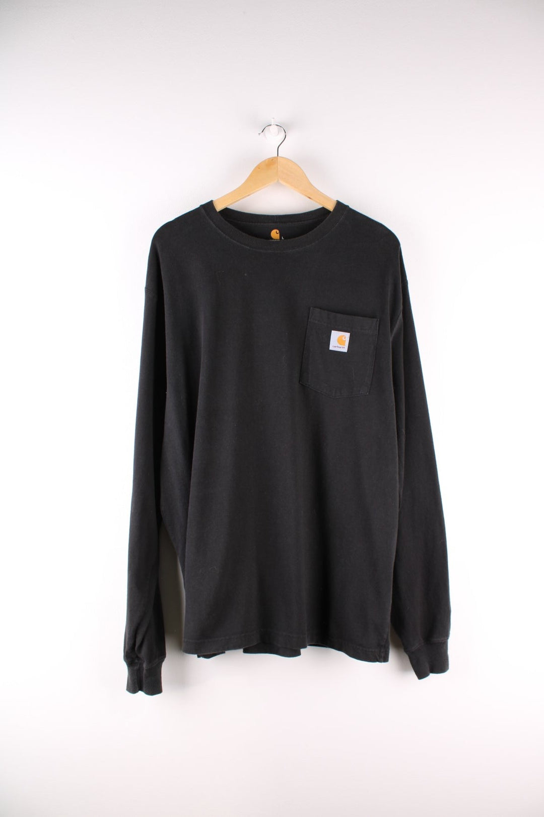 Carhartt longsleeve T-Shirt in a black colourway with a patch pocket, and logo embroidered on the front.