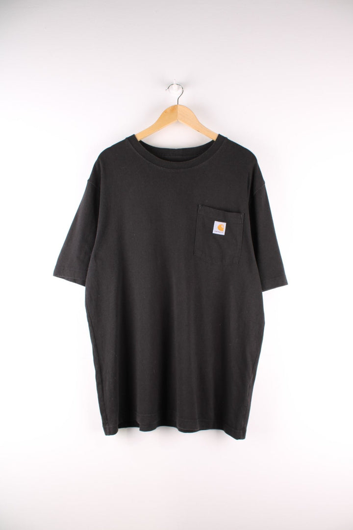 Carhartt T-Shirt in a black colourway with a patch pocket and logo stitched onto the front. 