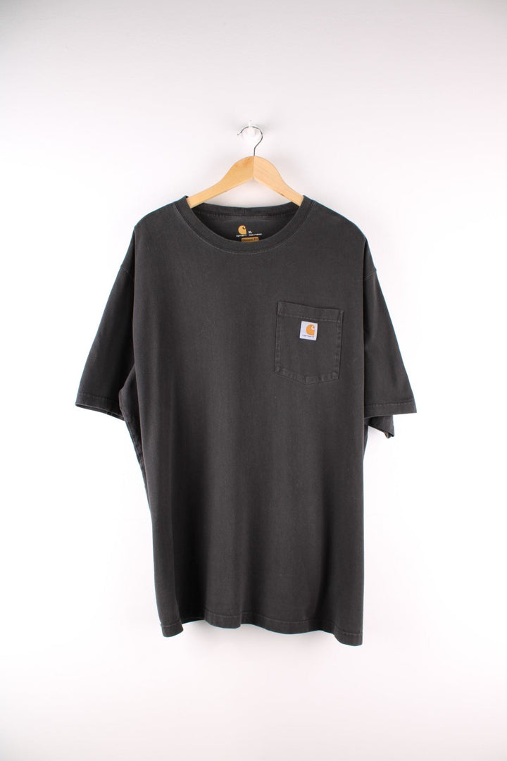 Carhartt T-Shirt in a black colourway with a patch pocket and logo stitched onto the front. 