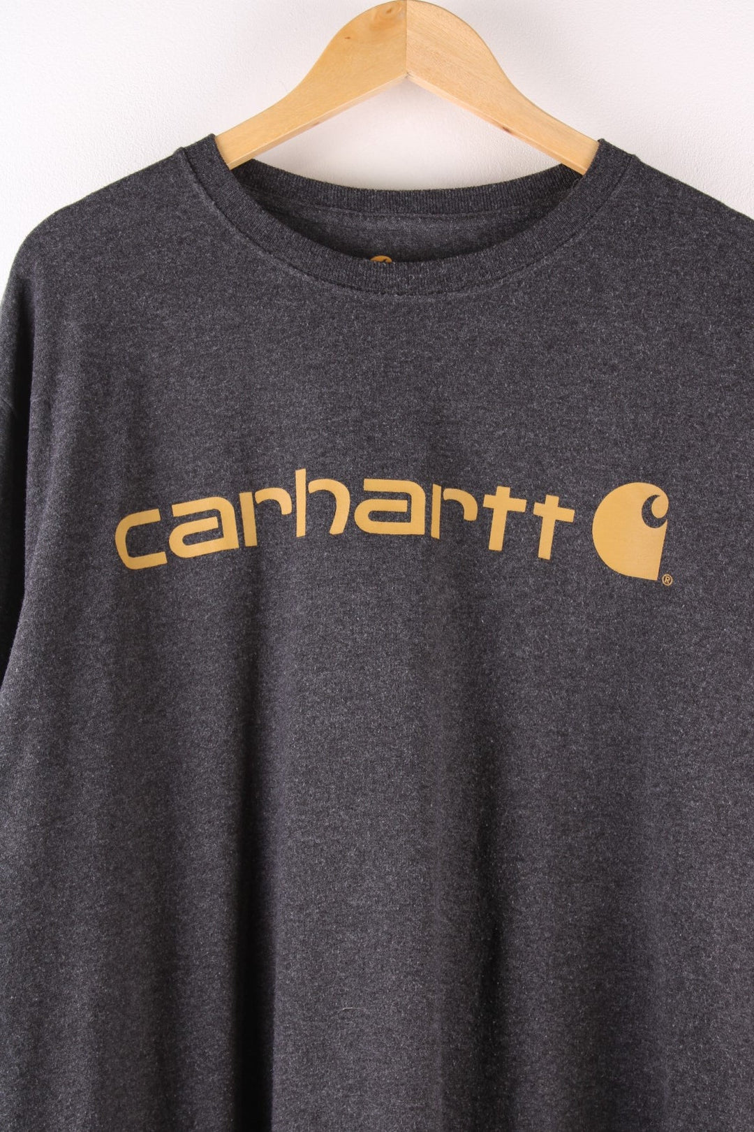 Carhartt T-Shirt in a dark grey colourway with a large orange logo printed on the front.