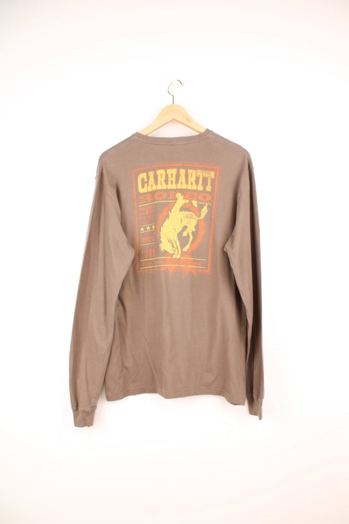 Carhartt Rodeo long sleeved top in brown, with graphic print on the chest and the back.