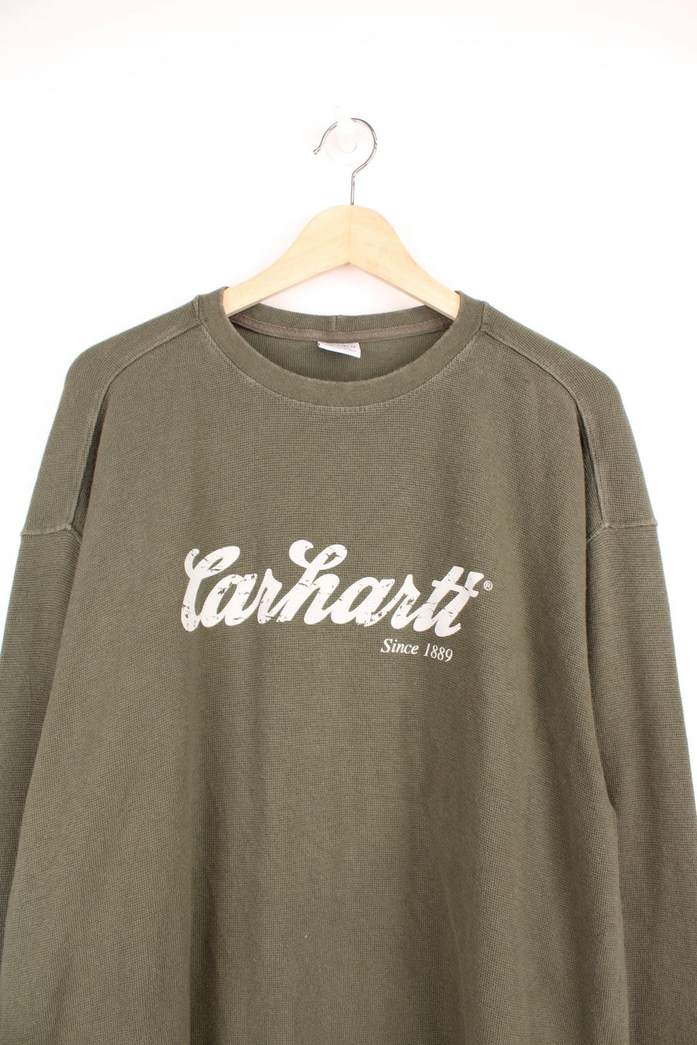 Carhartt long sleeved green waffle top with printed spell out logo across the chest.  