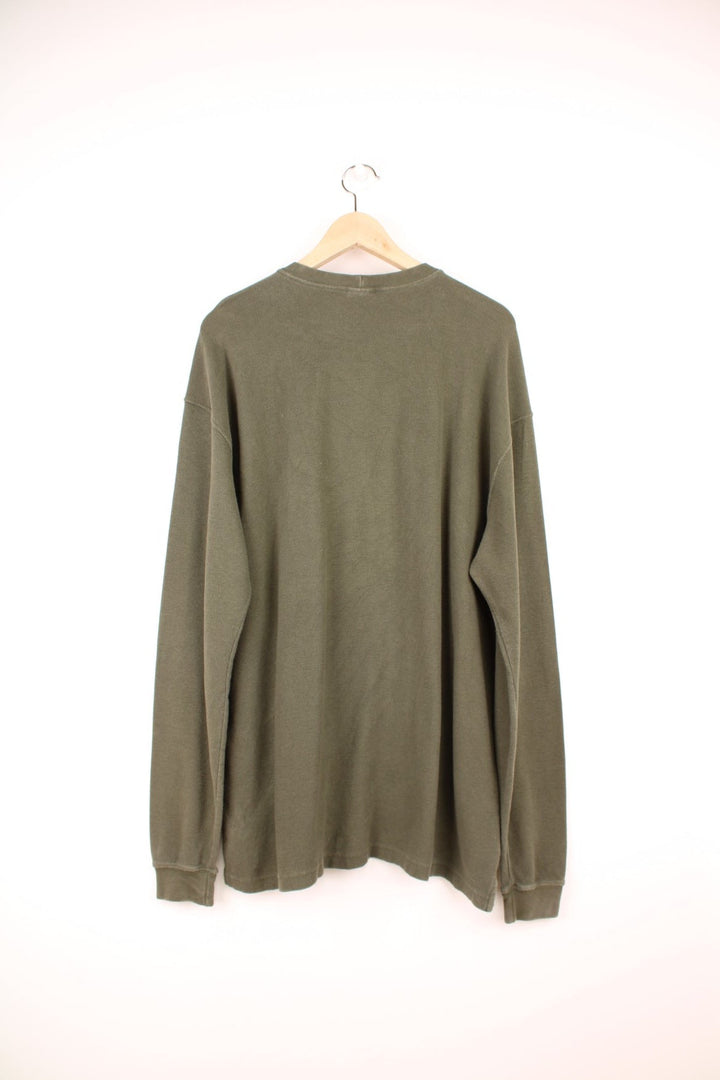 Carhartt long sleeved green waffle top with printed spell out logo across the chest.  