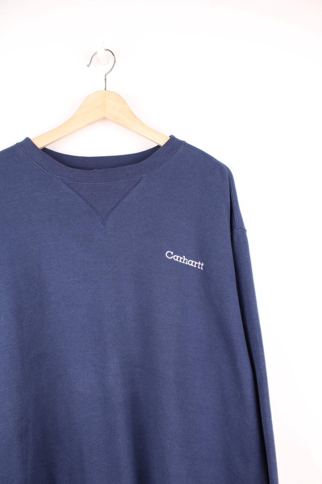 Navy blue Carhartt sweatshirt with white embroidered logo on the chest.