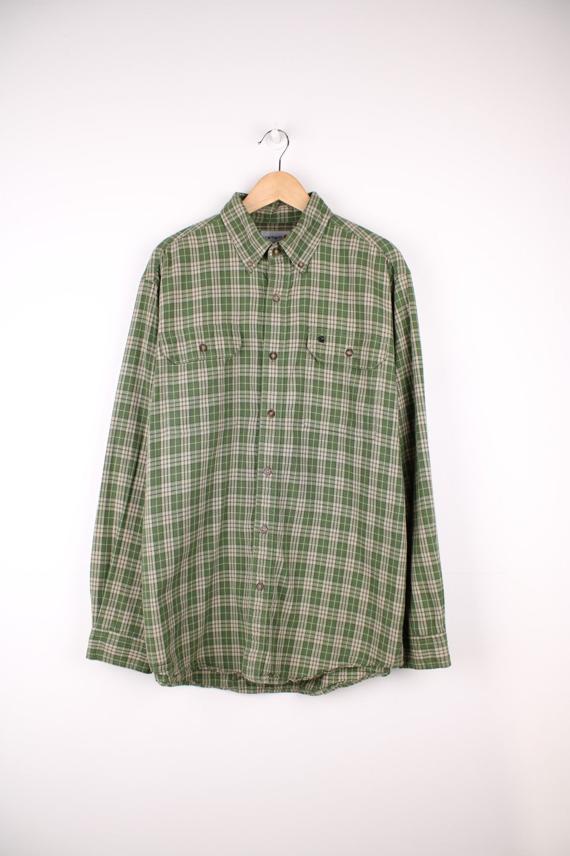 Carhartt green tone plaid button up cotton shirt with double chest pockets. Features signature embroidered logo on the pocket