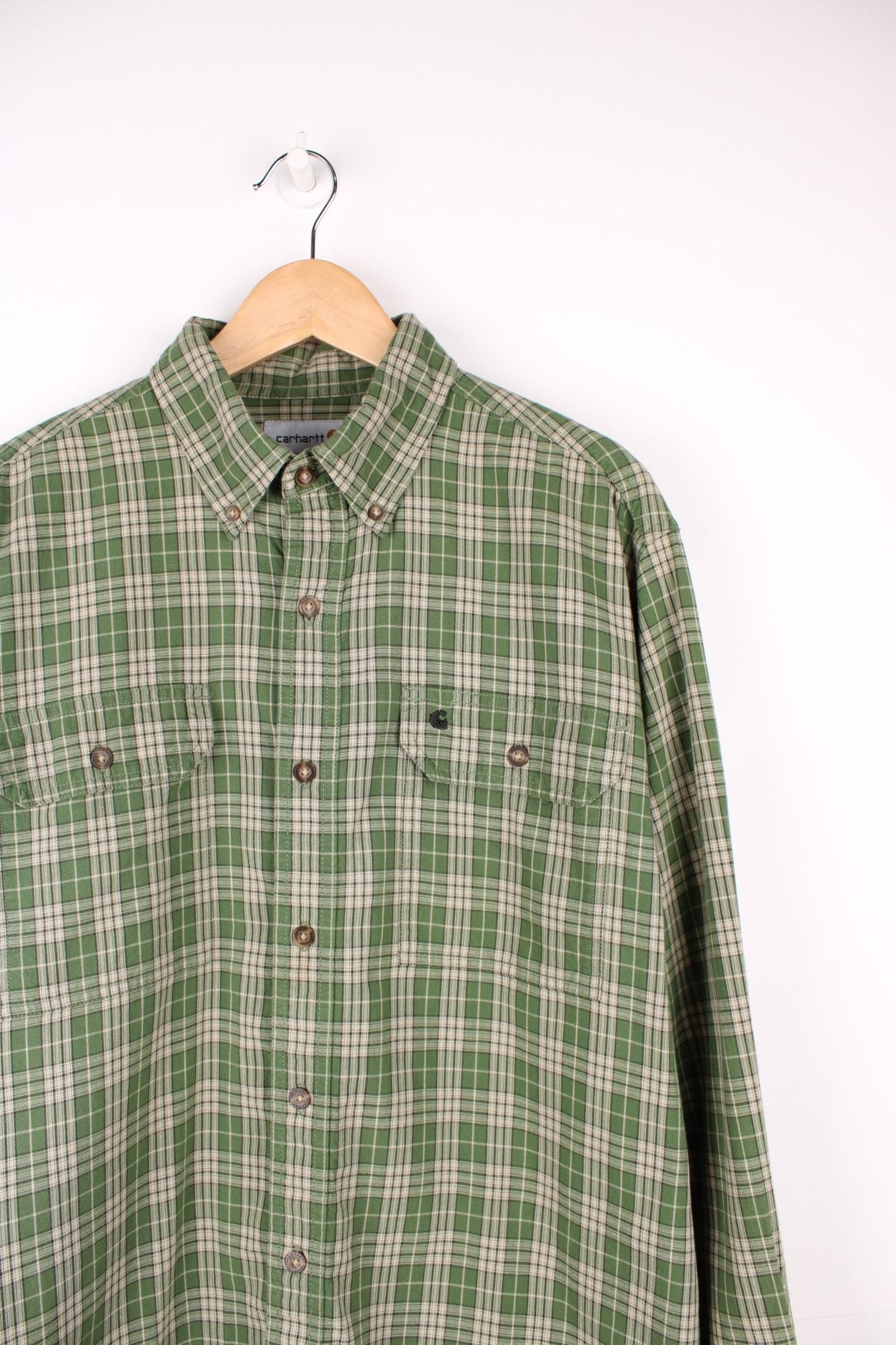 Carhartt green tone plaid button up cotton shirt with double chest pockets. Features signature embroidered logo on the pocket