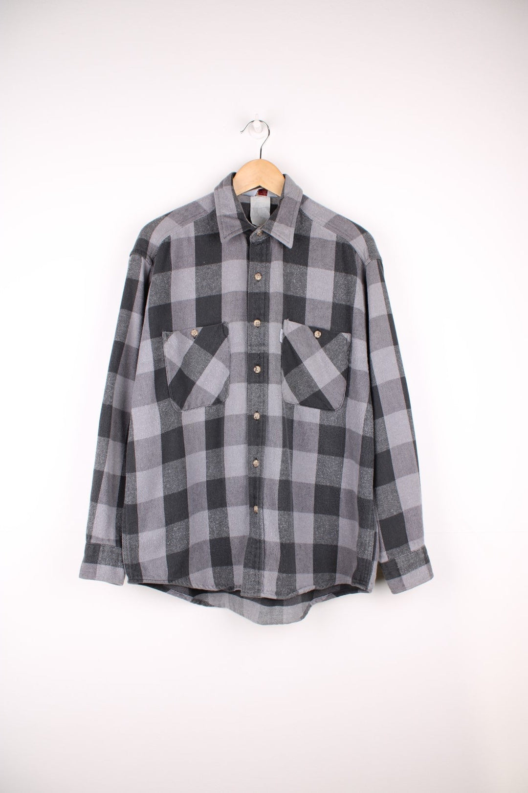 Carhartt black and grey tone button up flannel shirt. Made from 100% cotton, features double chest pockets and logo tag on the pocket