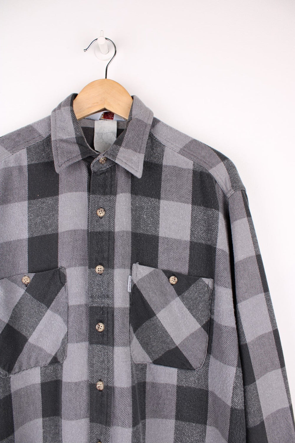 Carhartt black and grey tone button up flannel shirt. Made from 100% cotton, features double chest pockets and logo tag on the pocket