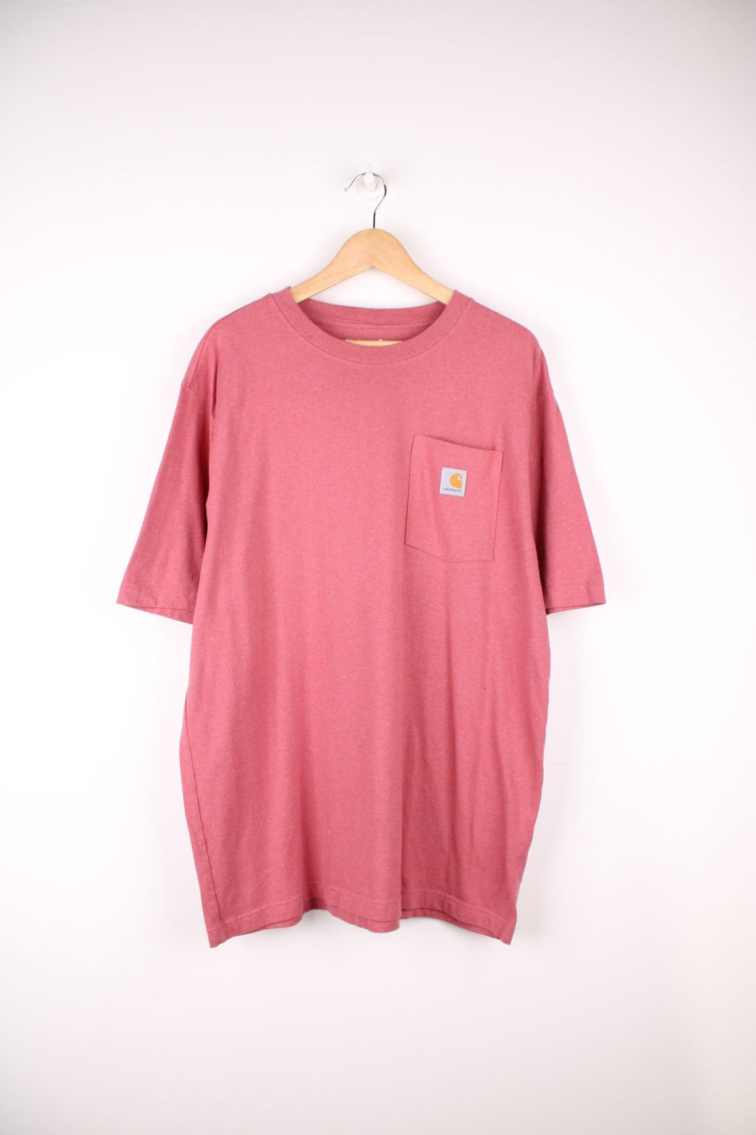 Carhartt pink 'loose fit' t-shirt with chest pocket. Features signature logo on the pocket