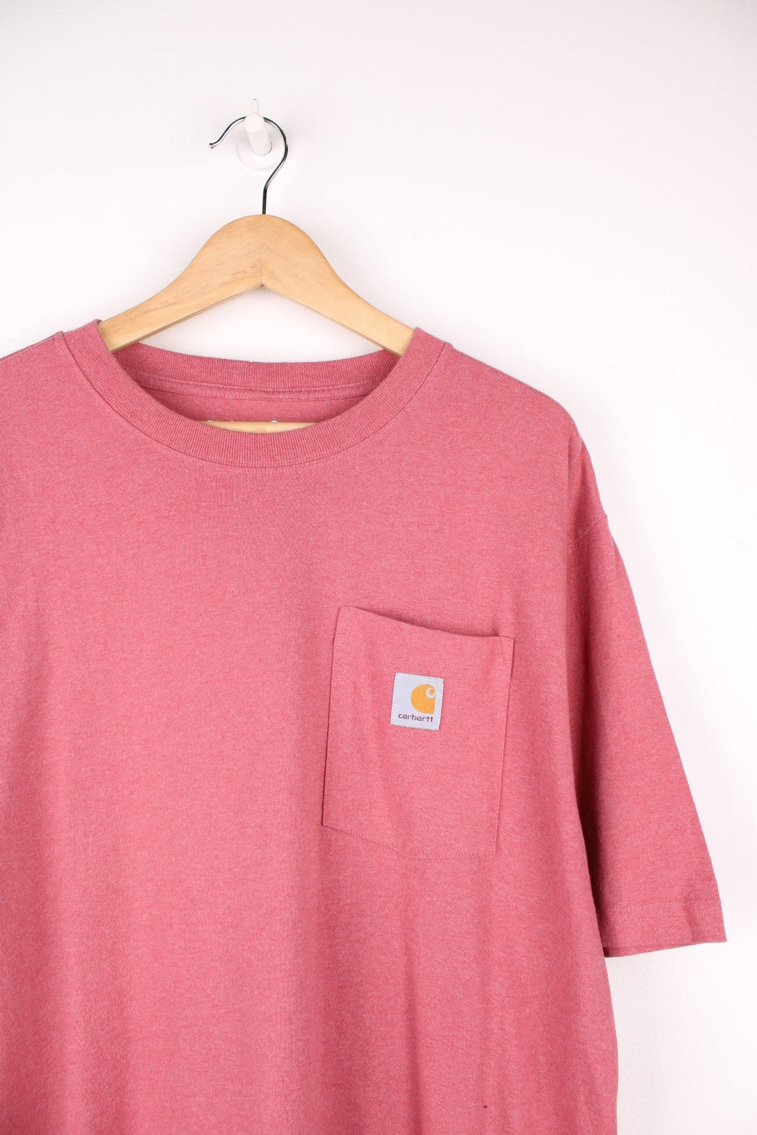 Carhartt pink 'loose fit' t-shirt with chest pocket. Features signature logo on the pocket