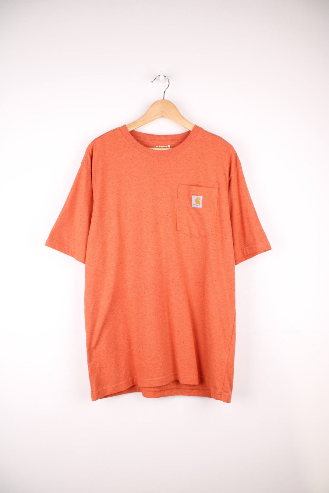 Carhartt orange 'loose fit' t-shirt with chest pocket. Features signature logo on the pocket