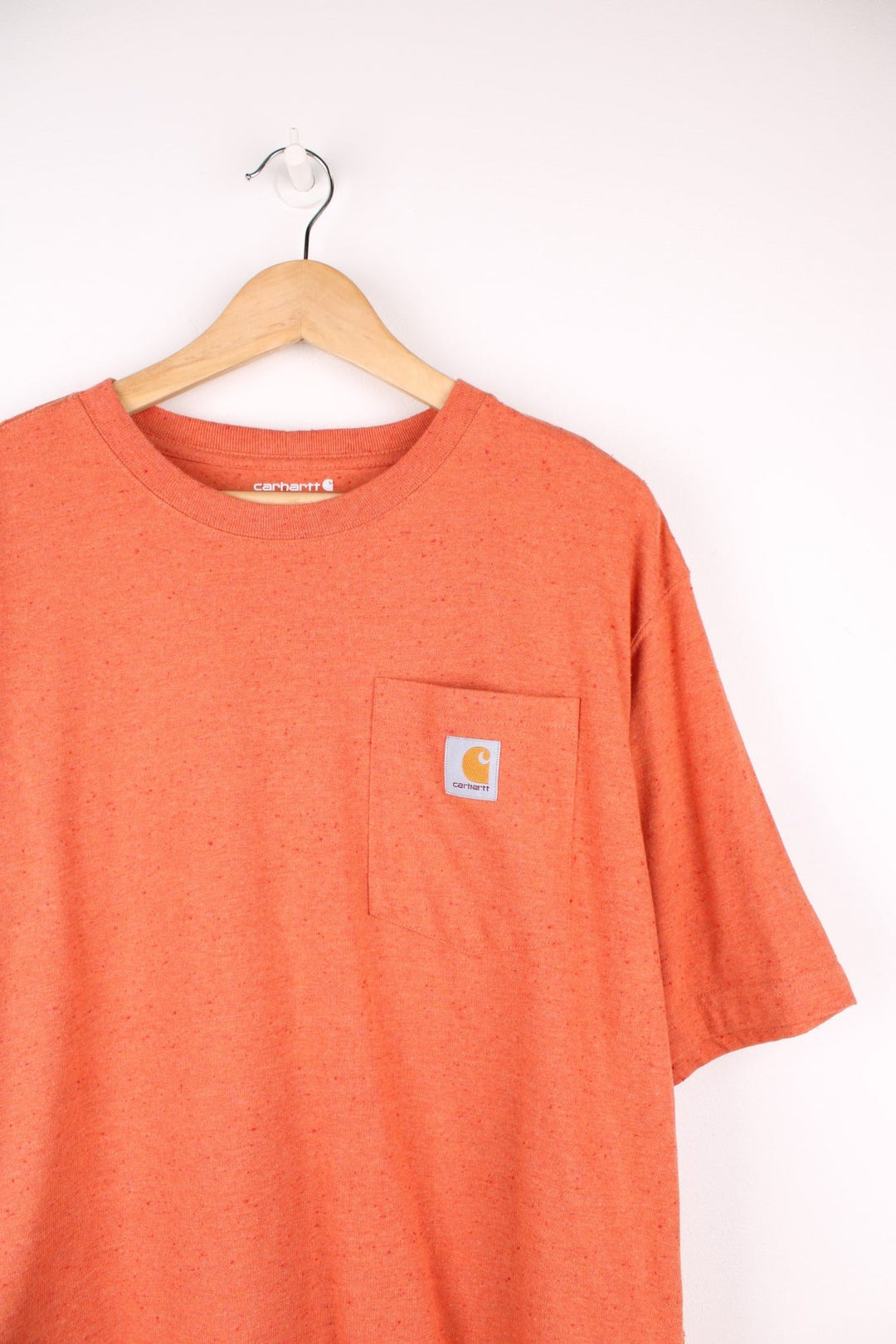 Carhartt orange 'loose fit' t-shirt with chest pocket. Features signature logo on the pocket