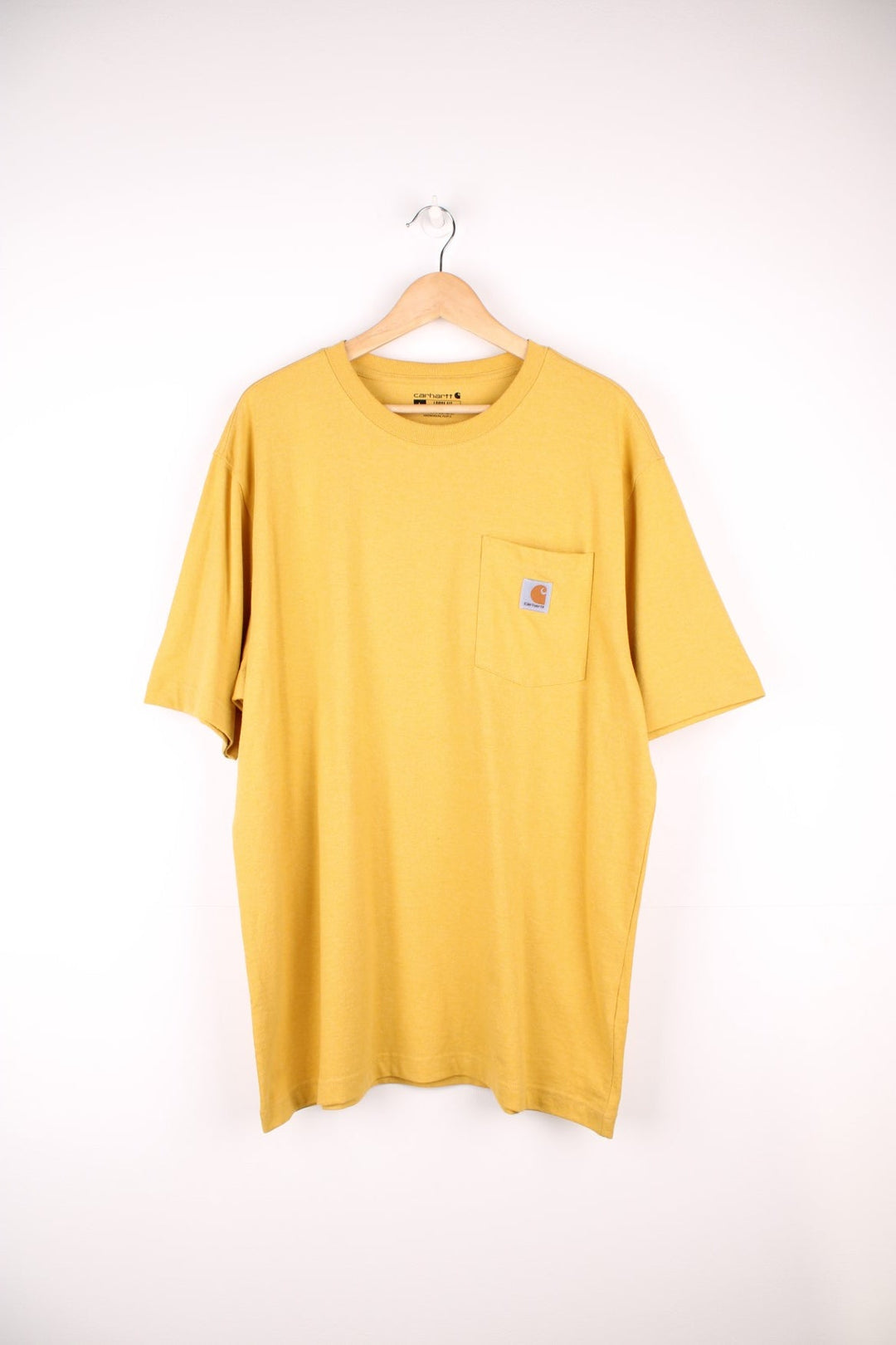 Carhartt yellow 'loose fit' t-shirt with chest pocket. Features signature logo on the pocket