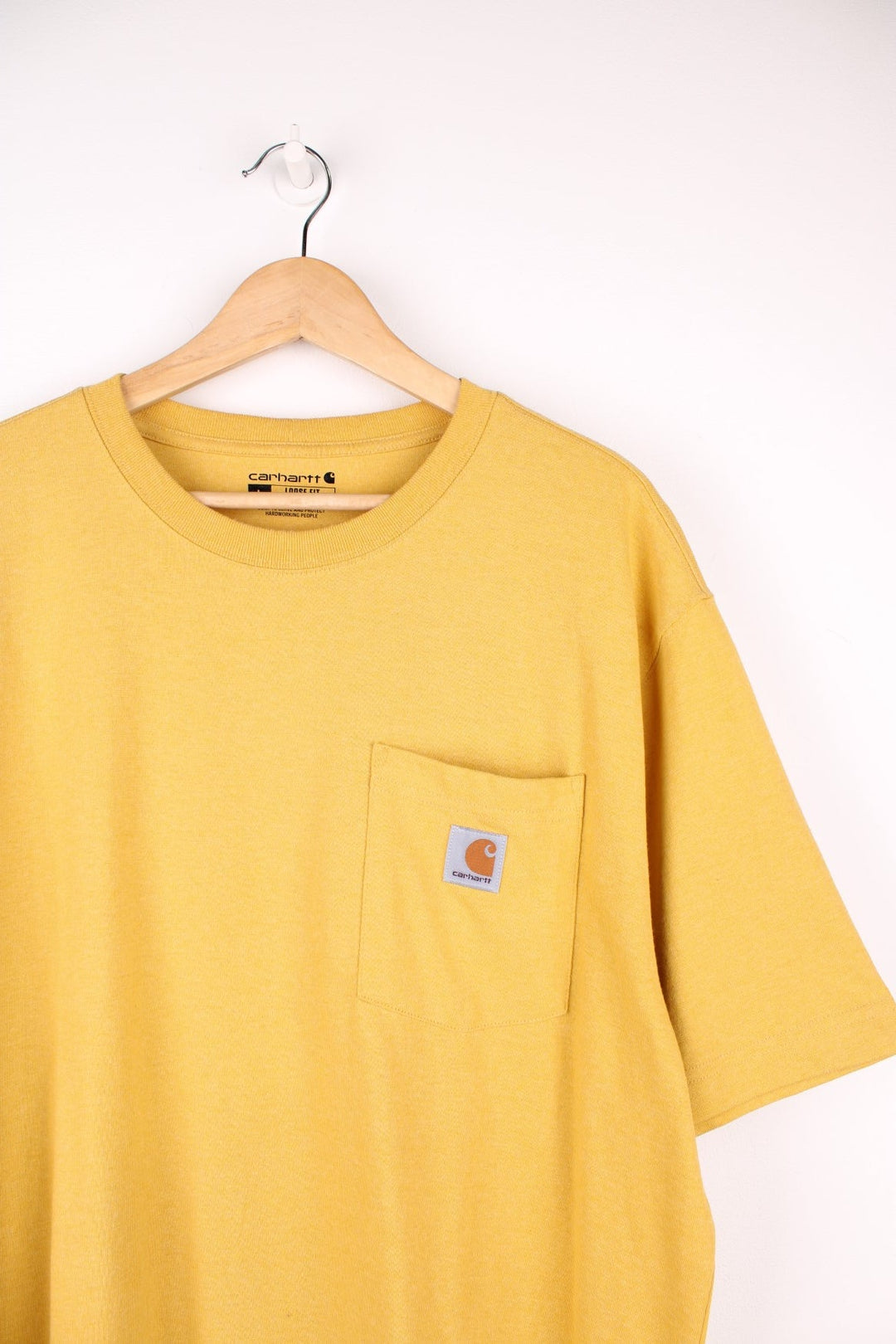 Carhartt yellow 'loose fit' t-shirt with chest pocket. Features signature logo on the pocket