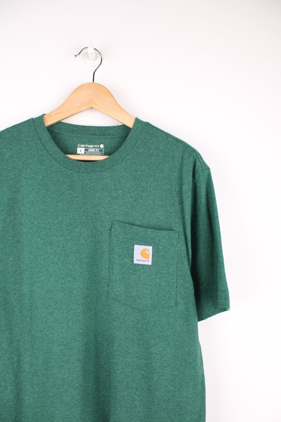 Carhartt green 'loose fit' t-shirt with chest pocket. Features signature logo on the pocket