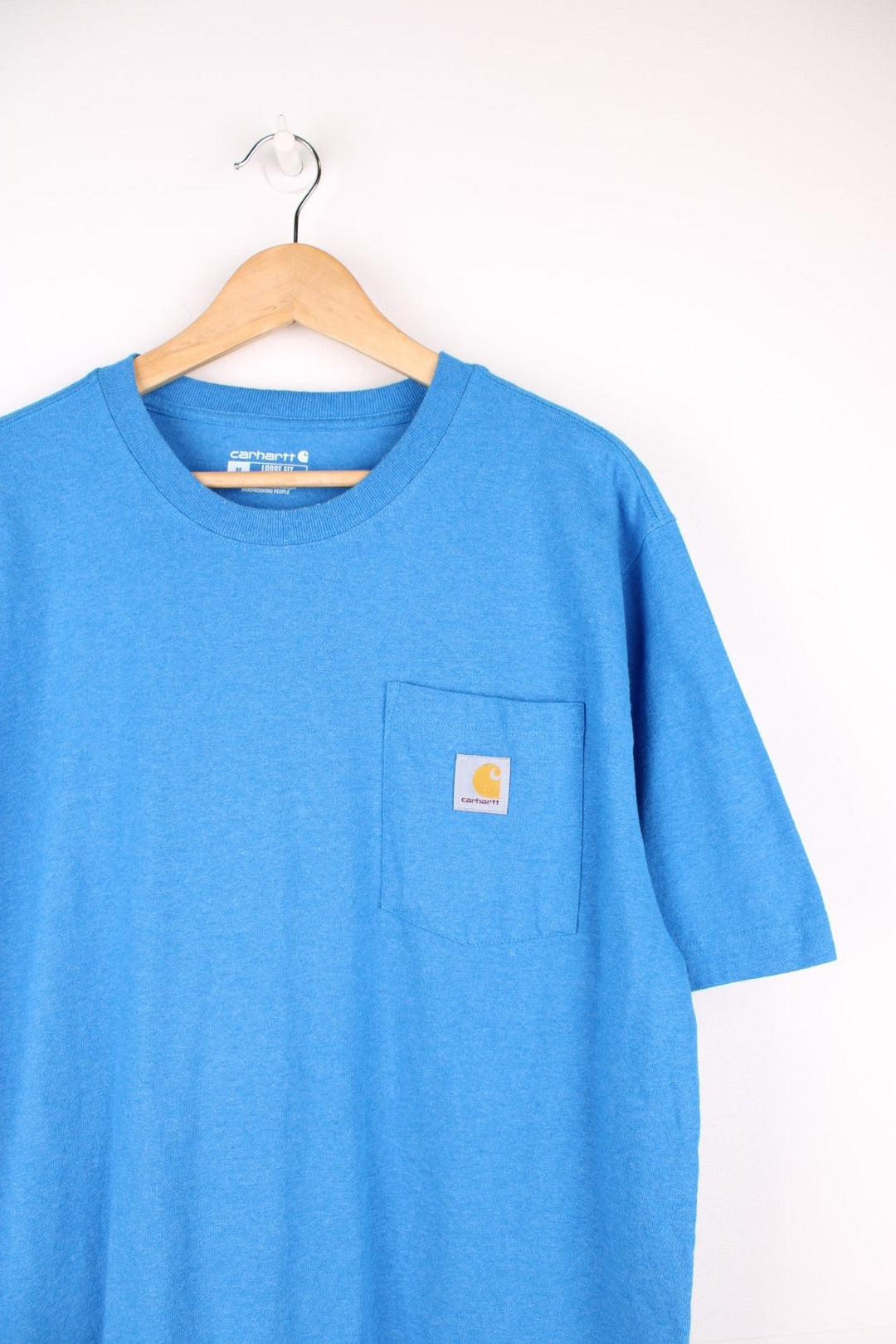 Carhartt blue 'loose fit' t-shirt with chest pocket. Features signature logo on the pocket