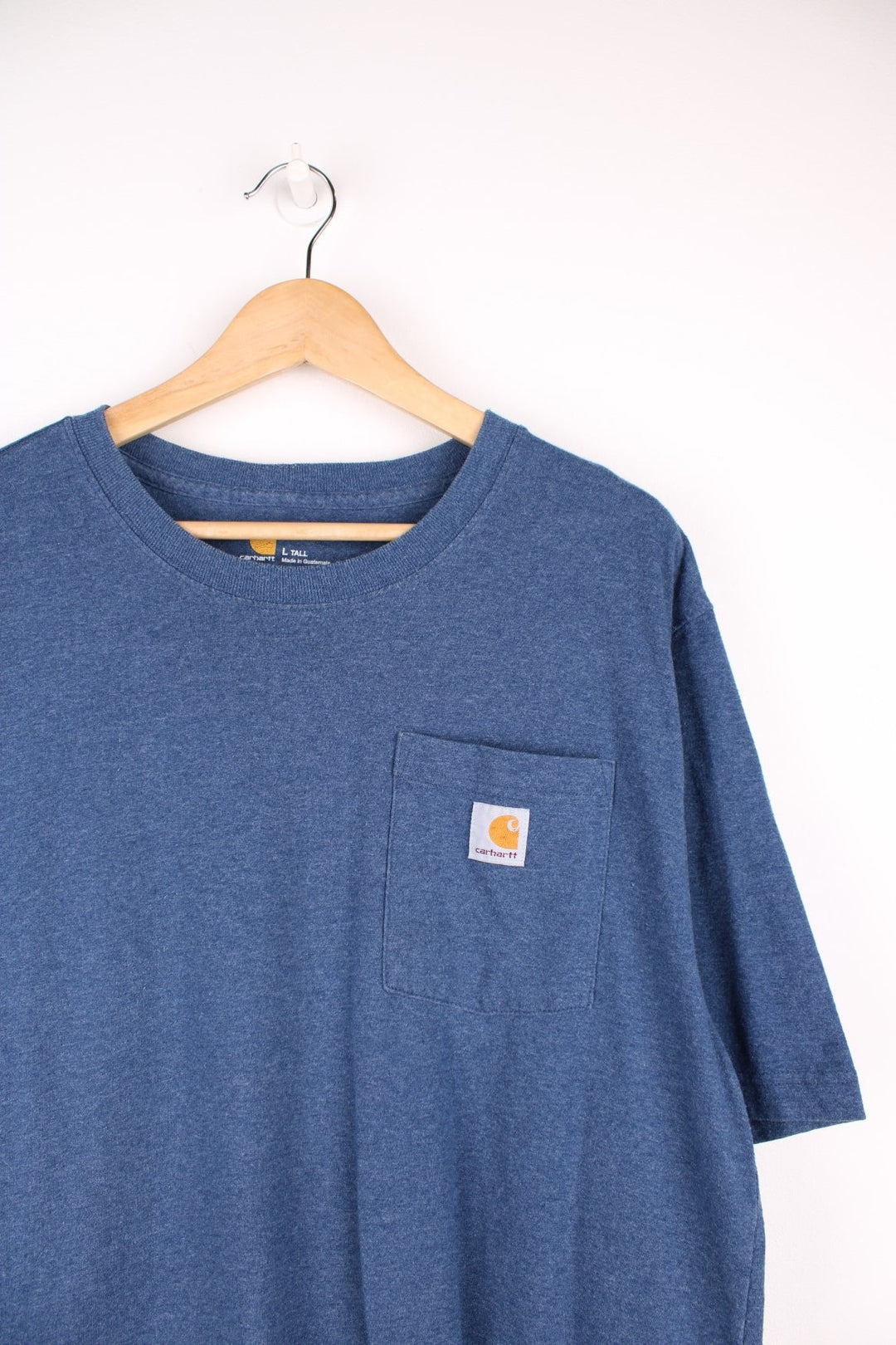 Carhartt blue 'loose fit' t-shirt with chest pocket. Features signature logo on the pocket