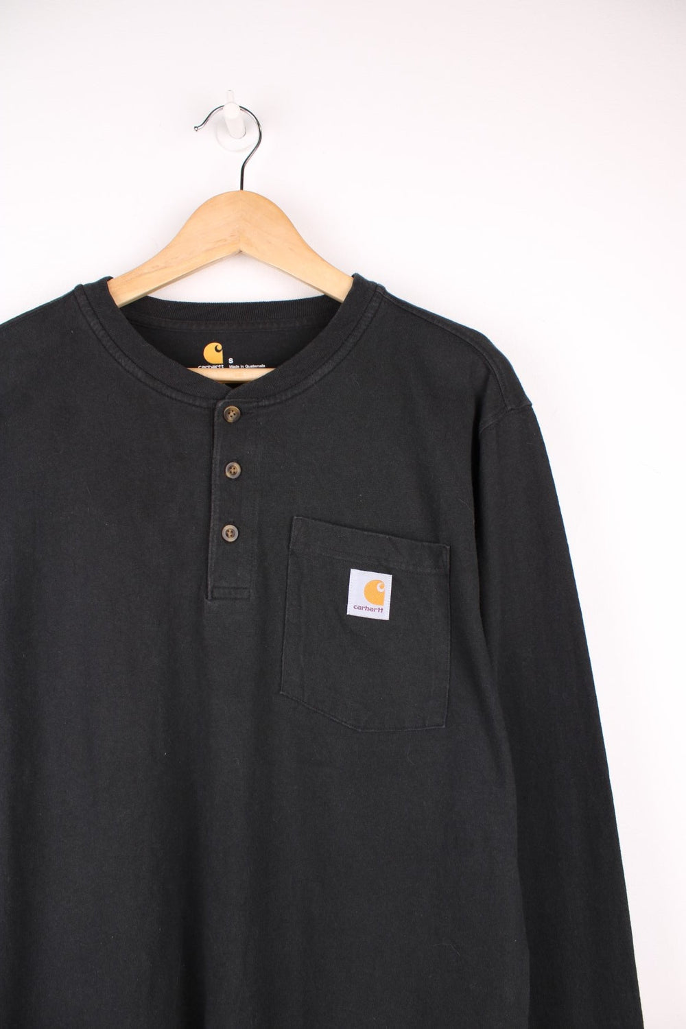 Carhartt 'original fit' black long sleeve top.Features signature logo on the chest pocket,three button fastening 