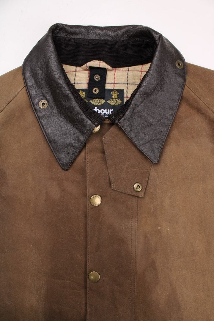 Barbour waxed jacket in brown with multiple pockets, zip closure, and a leather collar.