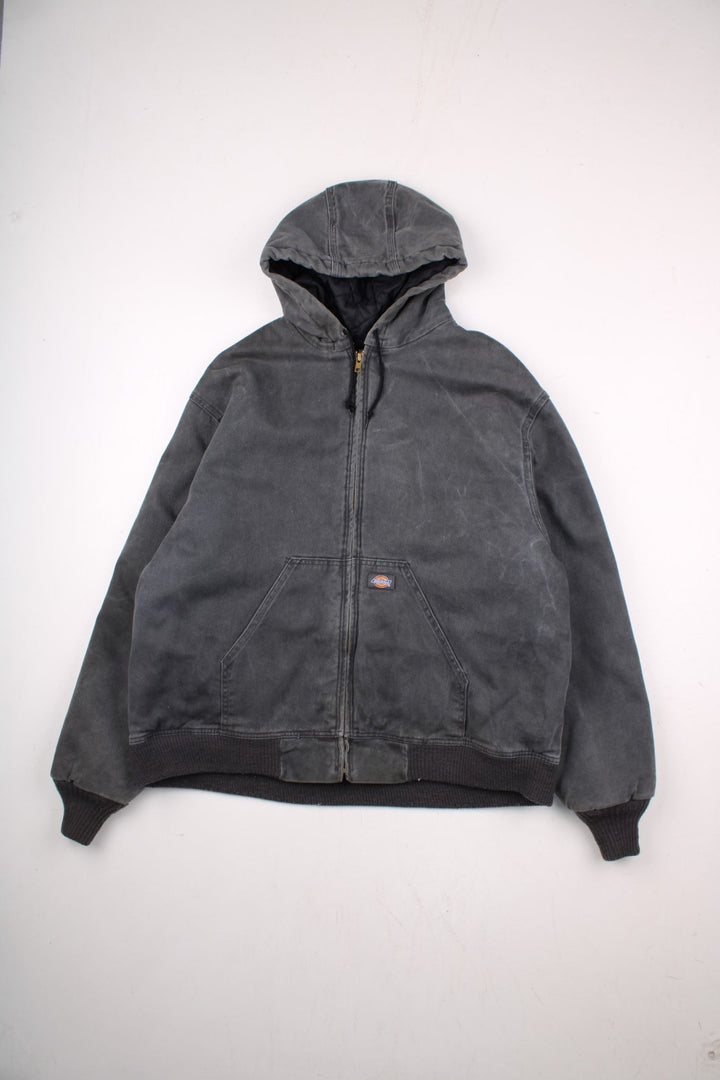 Dickies hooded work jacket in grey - quilt lined, with ribbed hem and cuffs, two pockets, zip closure, drawstring hood adjusters, and a small logo patch on the front.