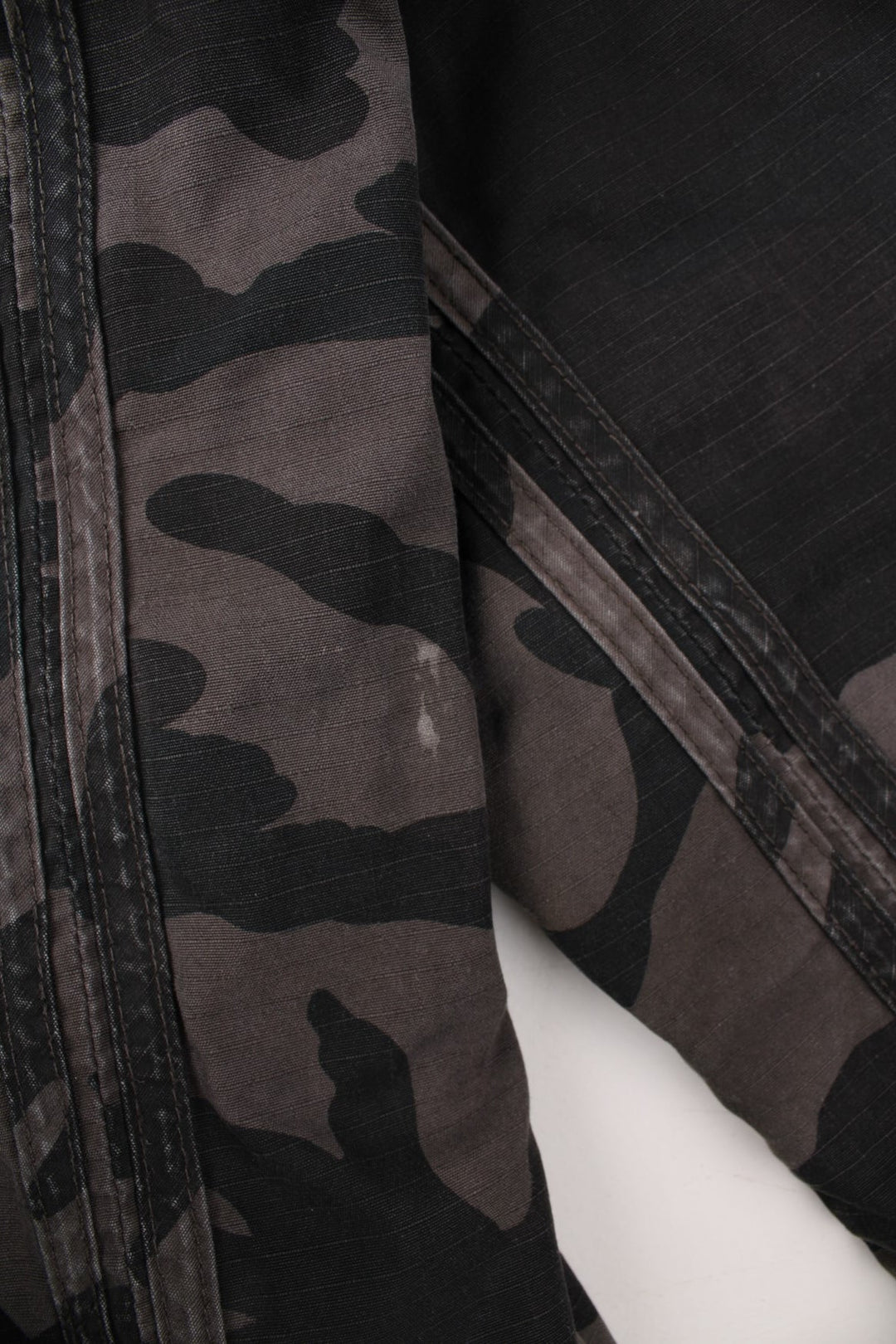 Bench fleece-lined camouflage coat in grey and black with zip closure, two pockets and a hood.