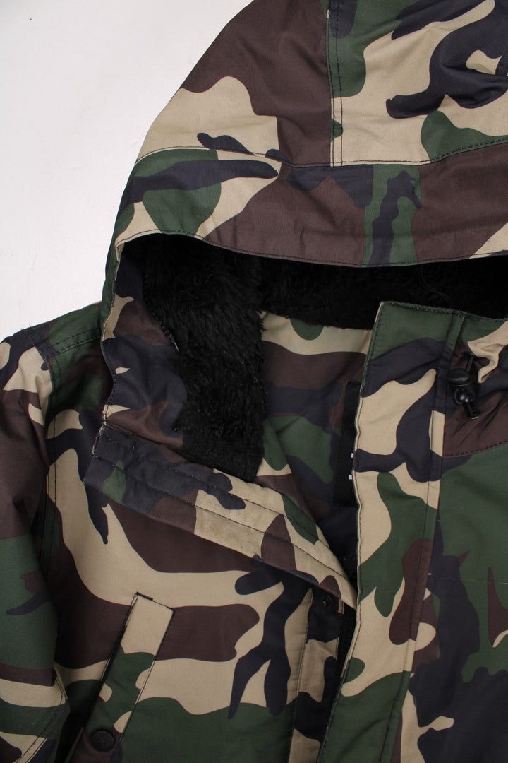 Dickies camouflage parka in green and brown - quilt-lined, with zip and snap closure, multiple pockets, and a sherpa-lined hood. Hood would have originally had detachable fur trim but this is missing.