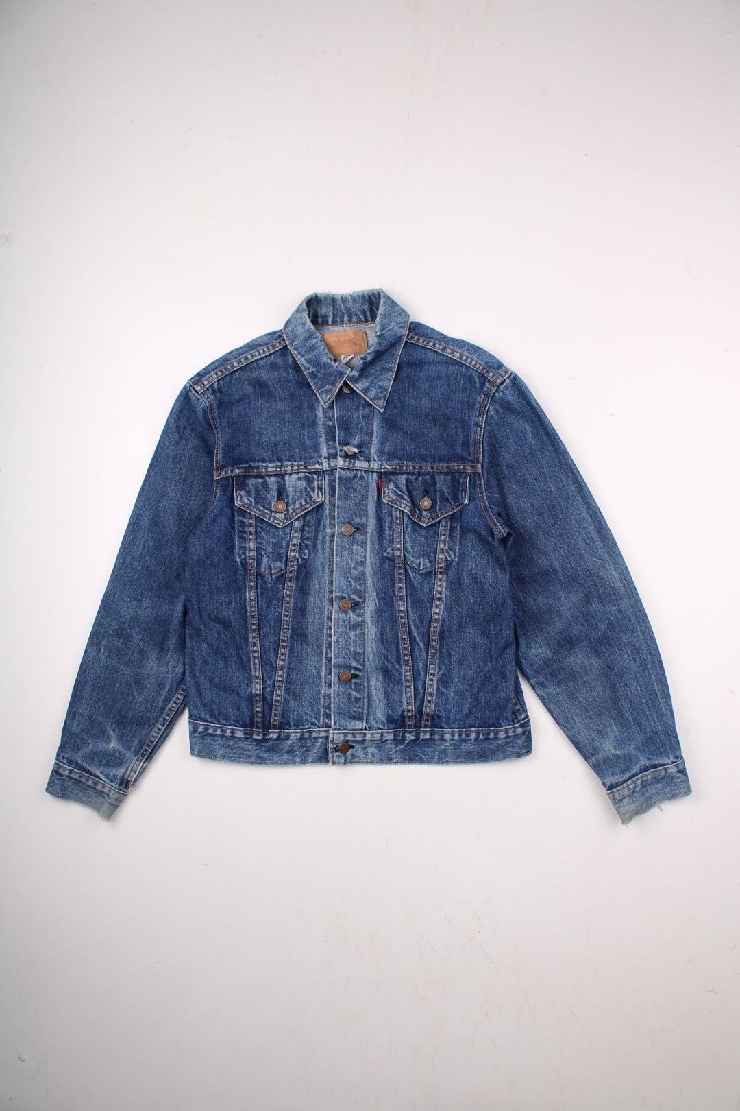 70s Levi Strauss Big E tab denim trucker jacket in blue with two chest pockets and button closure.