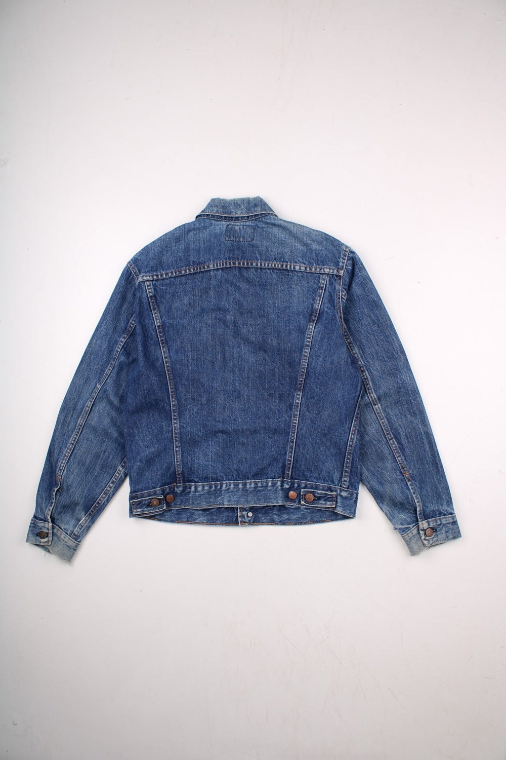 70s Levi Strauss Big E tab denim trucker jacket in blue with two chest pockets and button closure.