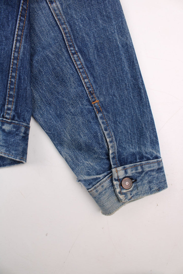 70s Levi Strauss Big E tab denim trucker jacket in blue with two chest pockets and button closure.