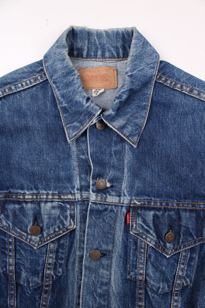 70s Levi Strauss Big E tab denim trucker jacket in blue with two chest pockets and button closure.