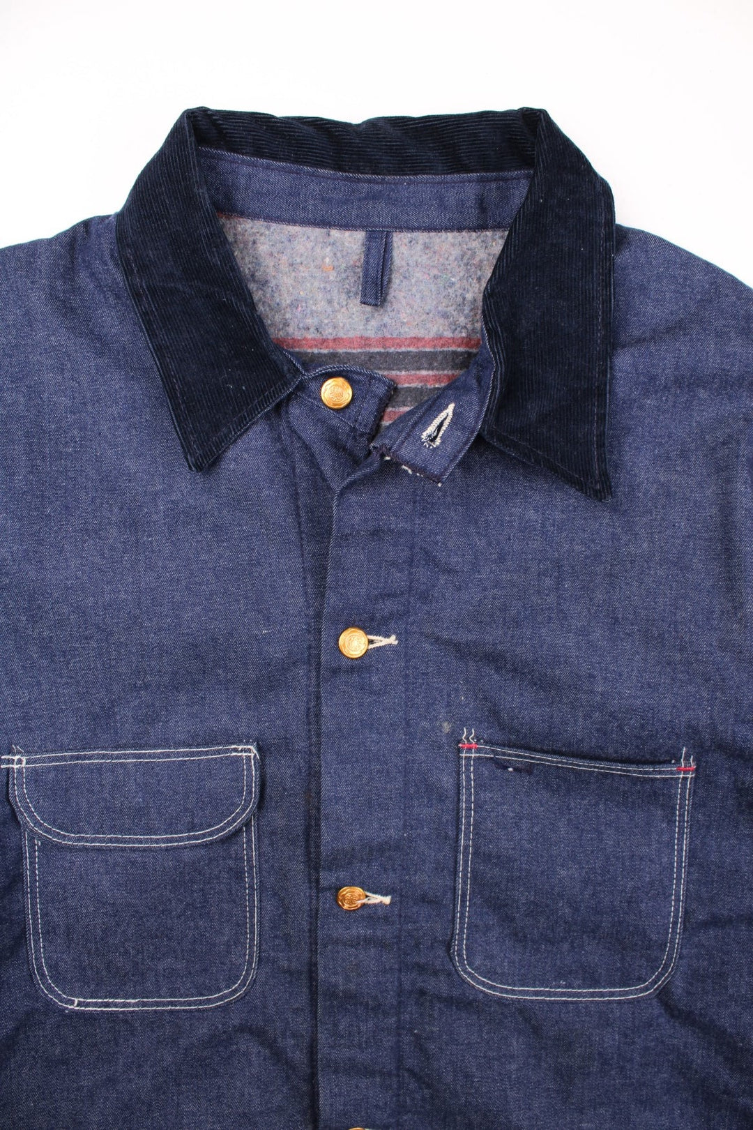 Vintage Blue Bell blanket lined denim chore jacket in indigo blue with four patch pockets, contrast stitching, and a corduroy collar.