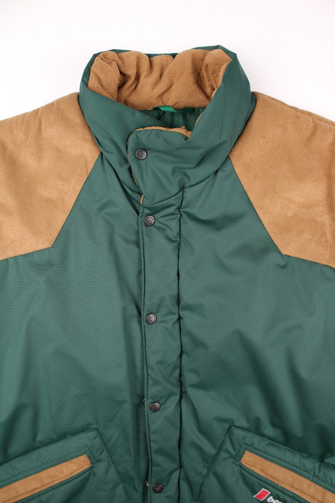 90s Berghaus 'Arctic Vest' gilet in green with tan faux suede detailing, zip and snap closure, two pockets, and an embroidered logo on the lower right side.