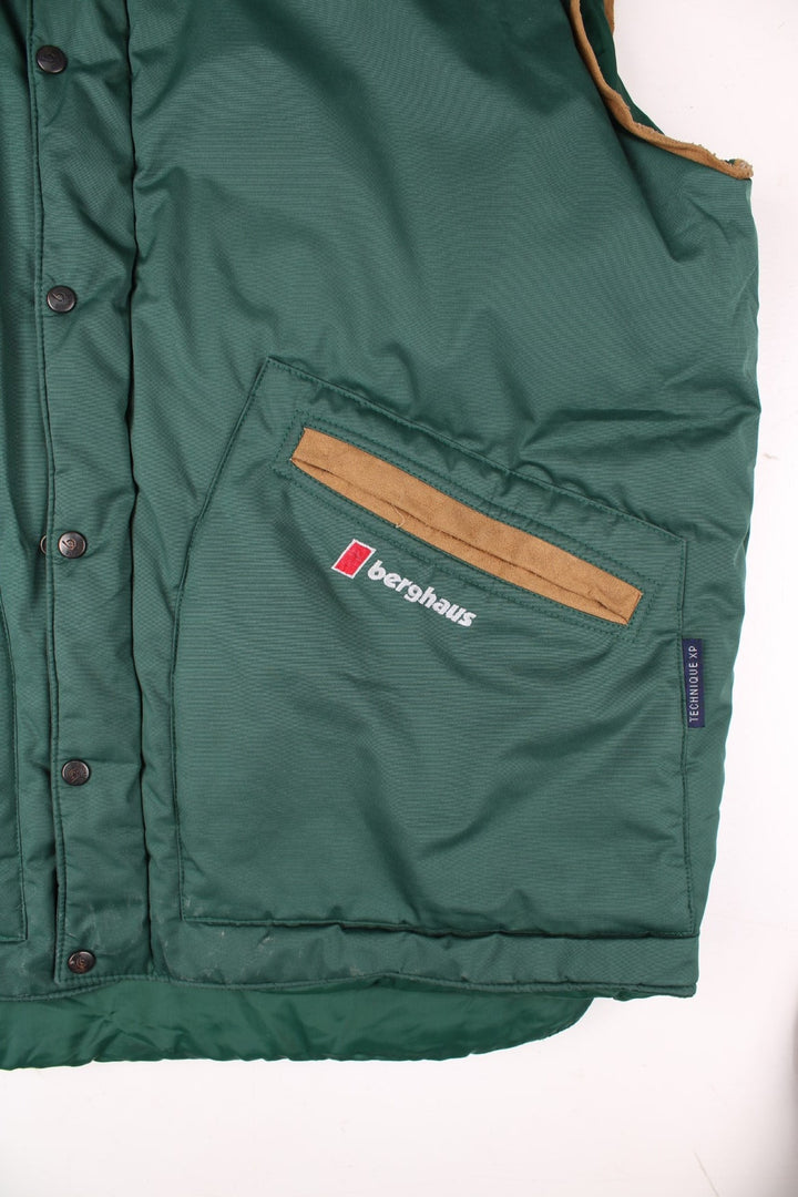 90s Berghaus 'Arctic Vest' gilet in green with tan faux suede detailing, zip and snap closure, two pockets, and an embroidered logo on the lower right side.