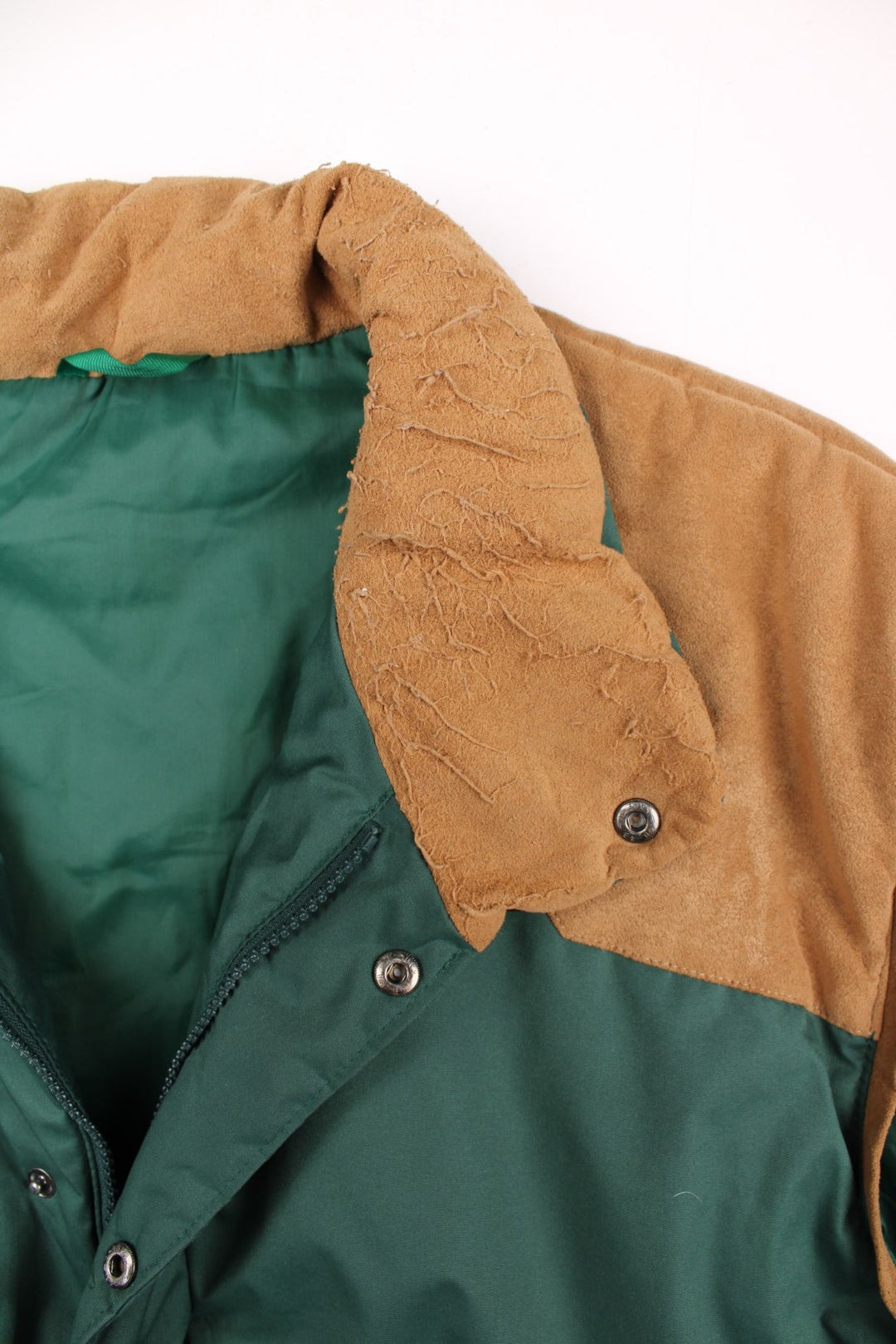 90s Berghaus 'Arctic Vest' gilet in green with tan faux suede detailing, zip and snap closure, two pockets, and an embroidered logo on the lower right side.