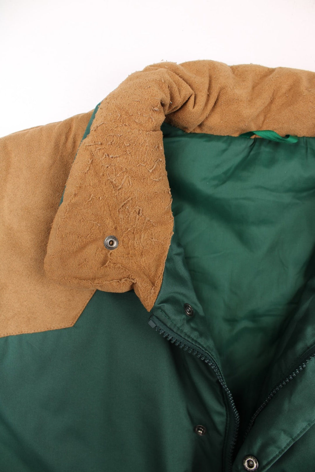 90s Berghaus 'Arctic Vest' gilet in green with tan faux suede detailing, zip and snap closure, two pockets, and an embroidered logo on the lower right side.