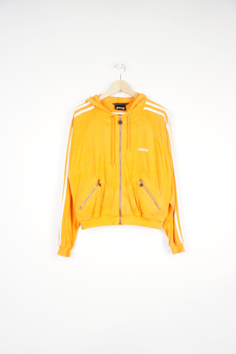 90's bright orange, terry cloth zip through Adidas hoodie, features embroidered logo on the chest and signature three stripes on the sleeve