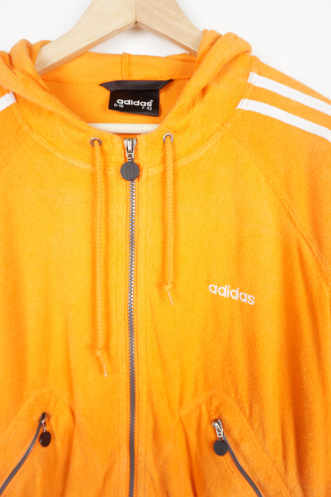 90's bright orange, terry cloth zip through Adidas hoodie, features embroidered logo on the chest and signature three stripes on the sleeve