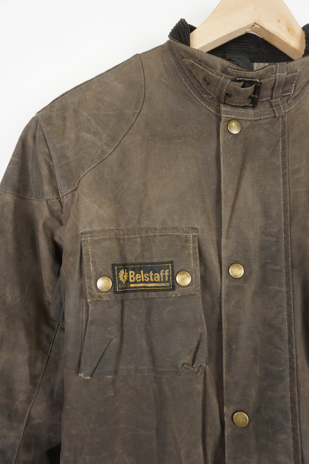 Women's Belstaff faded brown wax jacket with Belstaff logo on sleeve and pocket, plaid lining