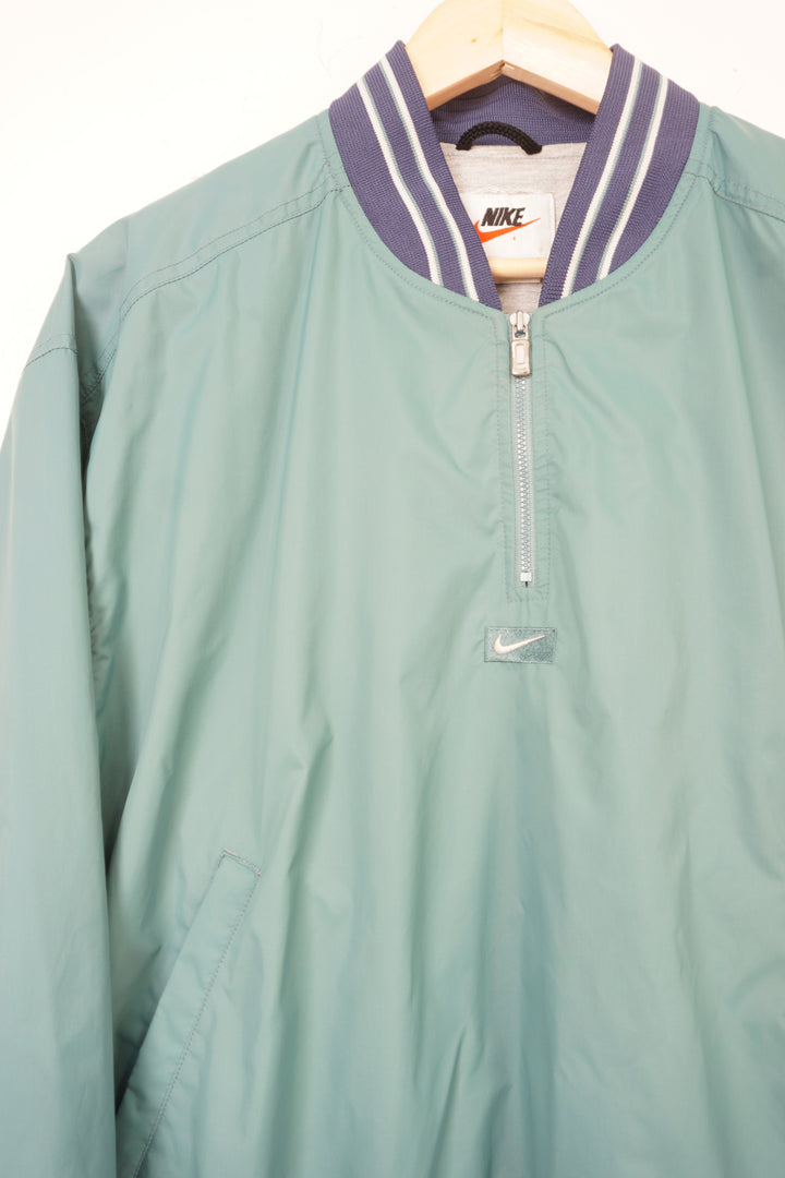 Vintage 90's light blue Nike 1/4 zip pullover jacket with embroidered logo on the chest and back