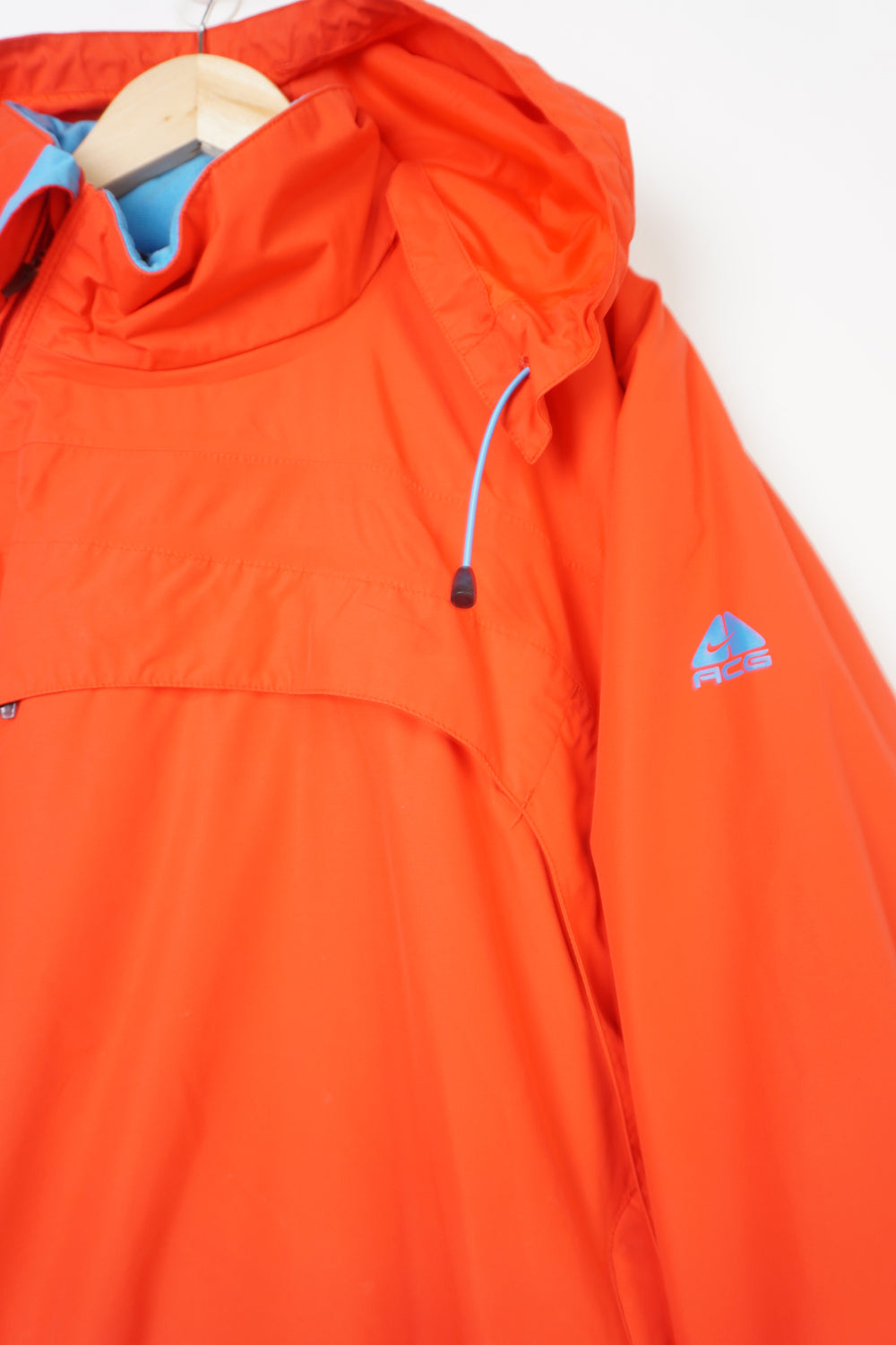 Nike ACG red and blue outdoor coat with foldaway hood and adjustable zip up sides