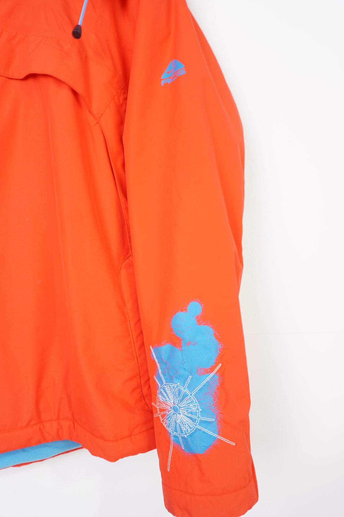 Nike ACG red and blue outdoor coat with foldaway hood and adjustable zip up sides