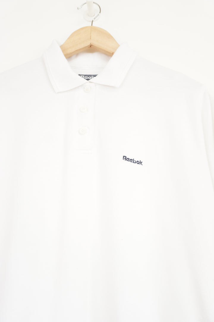 All white Reebok polo shirt with embroidered logo on the chest