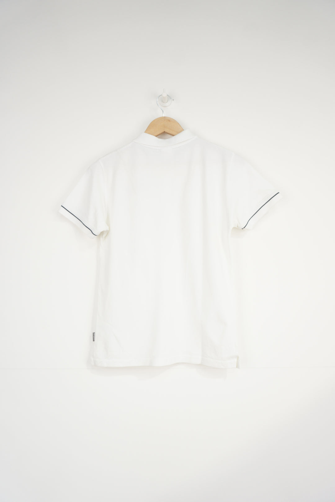 All white Reebok polo shirt with embroidered logo on the chest