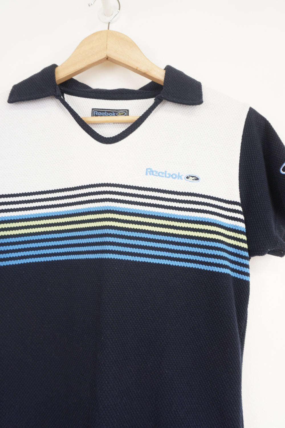 Navy blue Reebok Freestyle polo shirt with embroidered logo on the chest