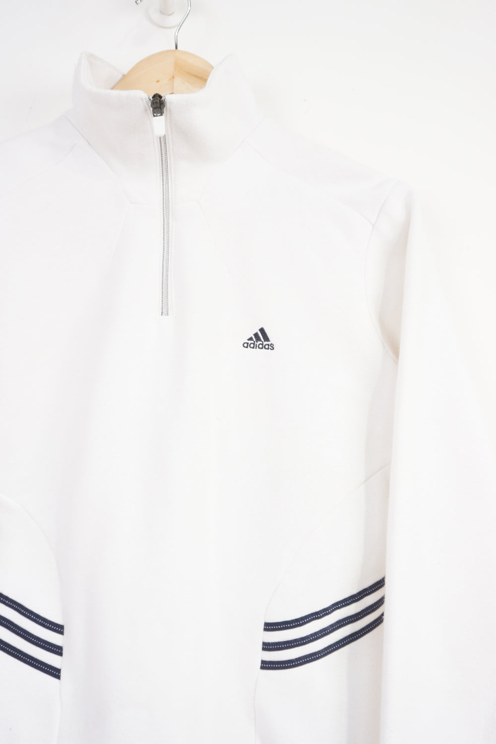 Adidas white 1/4 zip sweatshirt with navy blue embroidered logo on the chest and three stripes on the side 