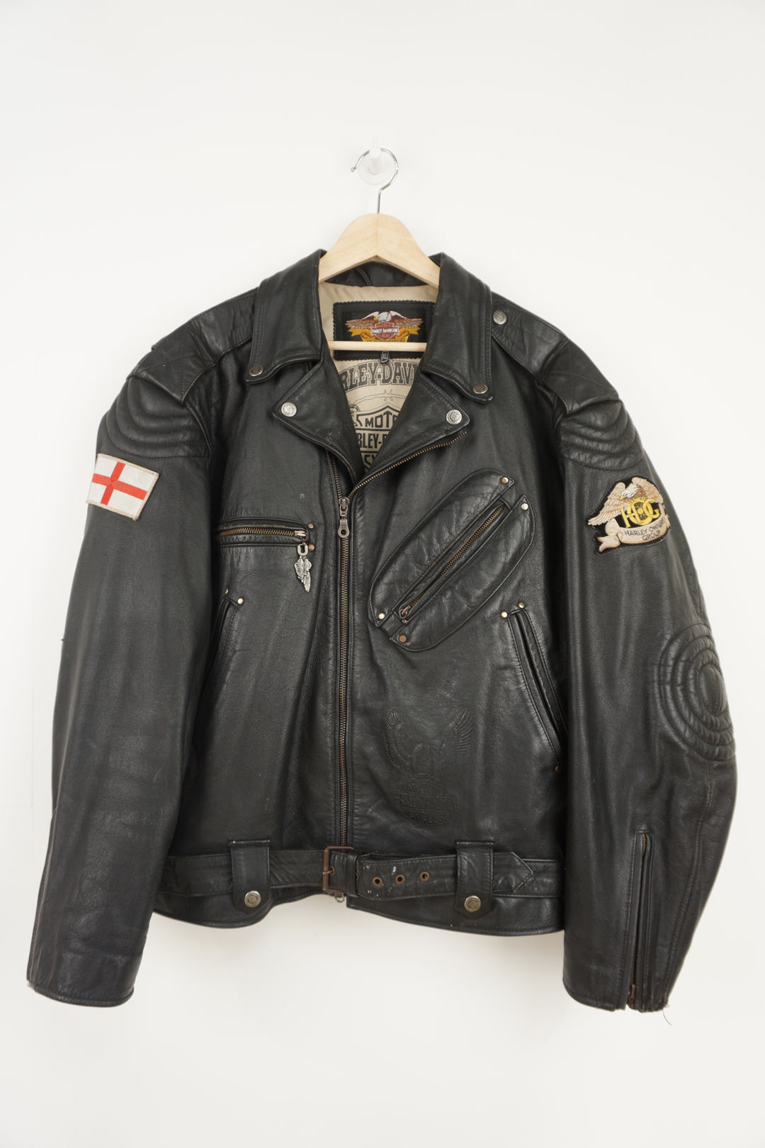 Vintage Harley Davidson black leather motorcycle jacket with embossed eagle design, embroidered badges and multiple pockets